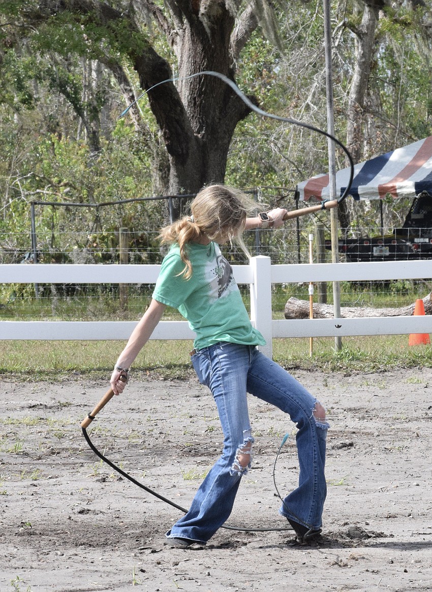 Myakka City's Madison Roberts shows off her whip cracking skills while using two whips.