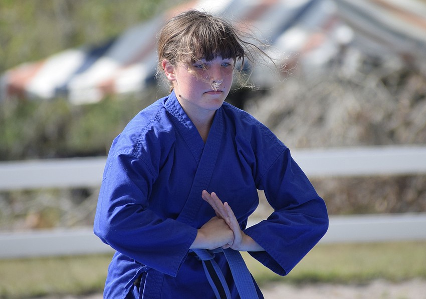 Sydney McCullough, who is 14, gives a karate demonstration during a fundraiser at Herrmann's Royal Lipizzan Stallions.