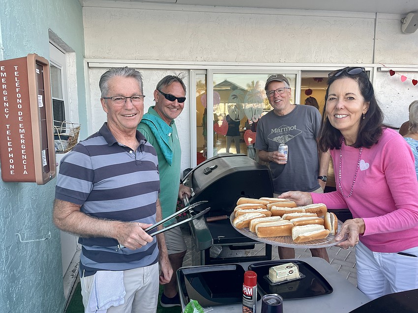 Ed Nelson, Graeme Morrison, Todd Phillips and Janet Shaffer serve the hot dogs and hamburgers.