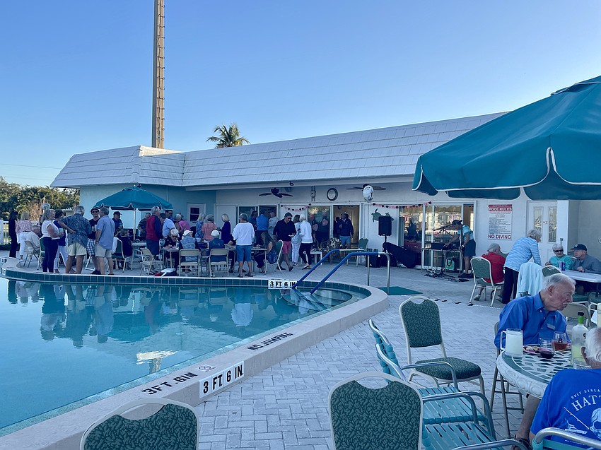 The crowd gathers outside and inside the clubhouse at the Spanish Main Yacht Club.