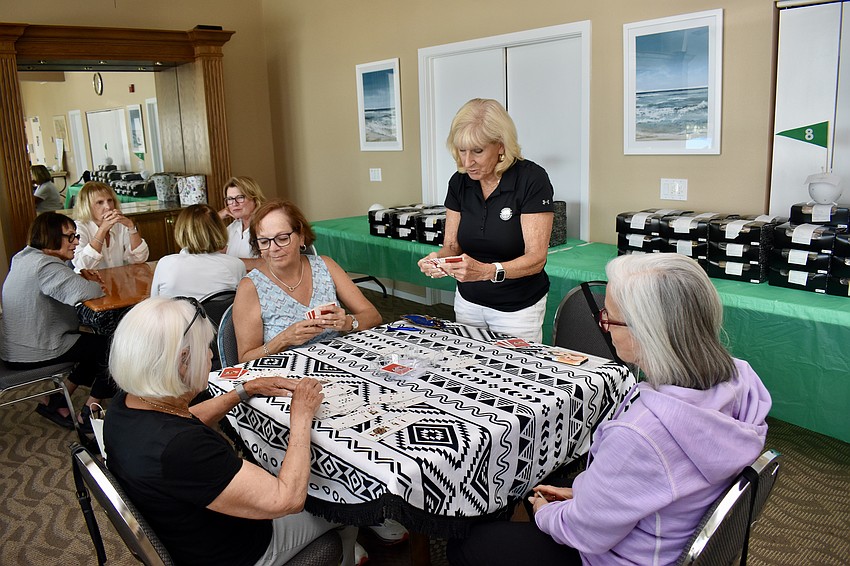 Box lunches and the card players await the golfers' return to the clubhouse.