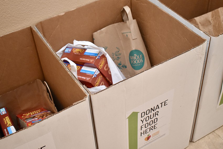 Players bring nonperishable food items for All Faiths Food Bank.