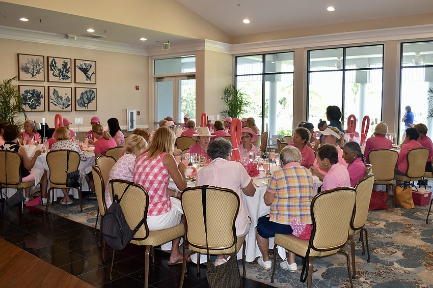 The golfers eat lunch in the Harbourside Ballroom after being on the course all morning.