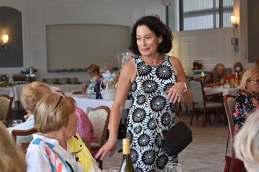 Gretchen Burns struts in a sleeveless dress.