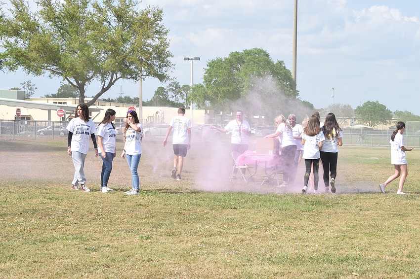 A mist of pink takes over the field as students walk by.