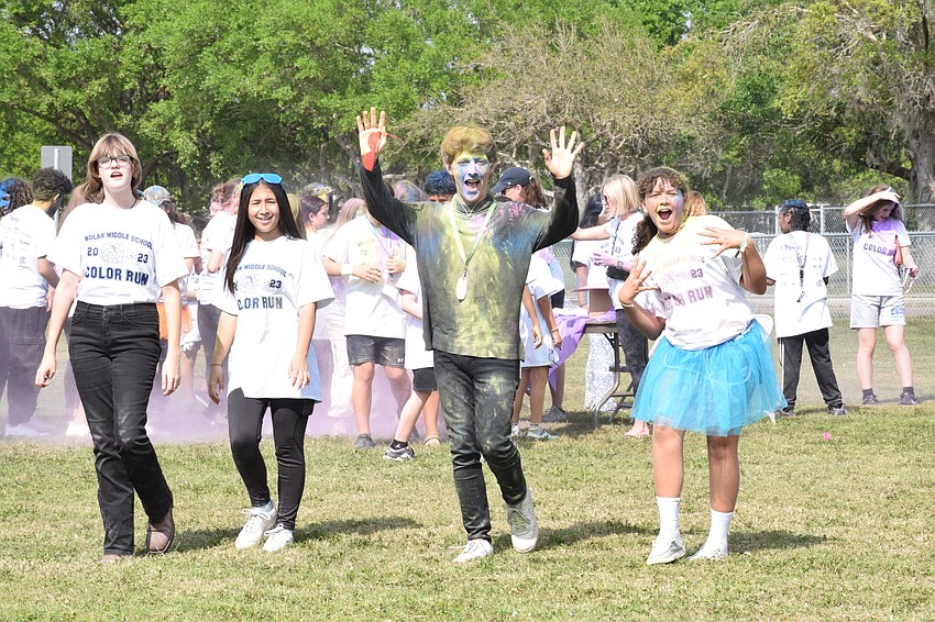Eighth graders Gabrielle Finnegan and Phoenix Theis, Lakewood Ranch High School sophomore Byron Simon and seventh grader Sylvie Theis make their way around the field, adding a little color each time.