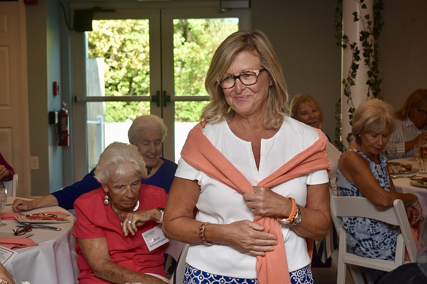 Liz Lammers shows off an orange cardigan from Tommy Bahama.