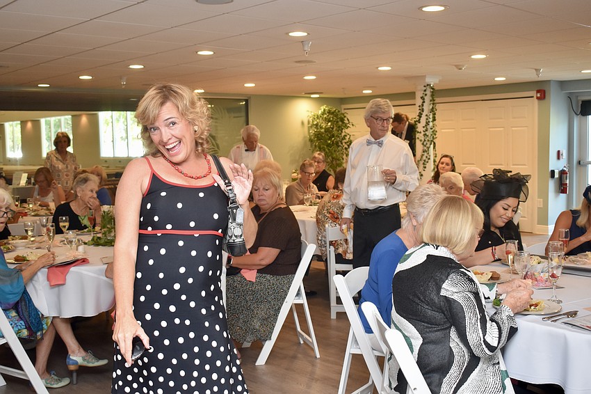 Patti Mae Bosco struts in a polka dot dress by Menu and accessorizes with a Coach purse.