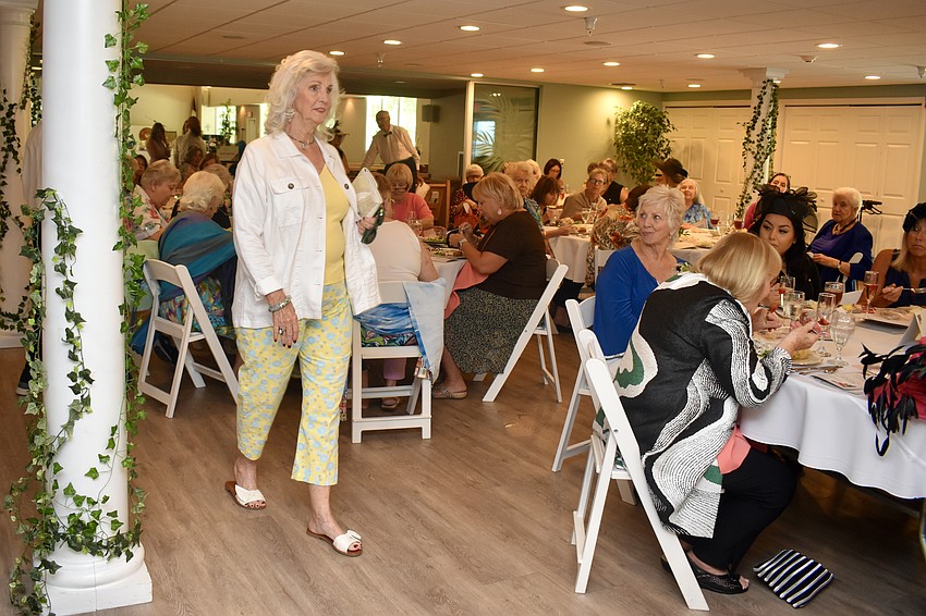 Sandra Johnson walks in a white linen jacket by J Jill.