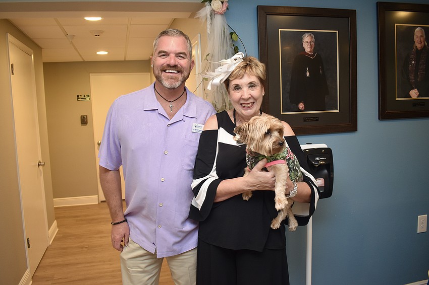 Rev. Brock Patterson and Karen Pashkow with Patterson's dog Pippa. Pippa is wearing a top that says, 