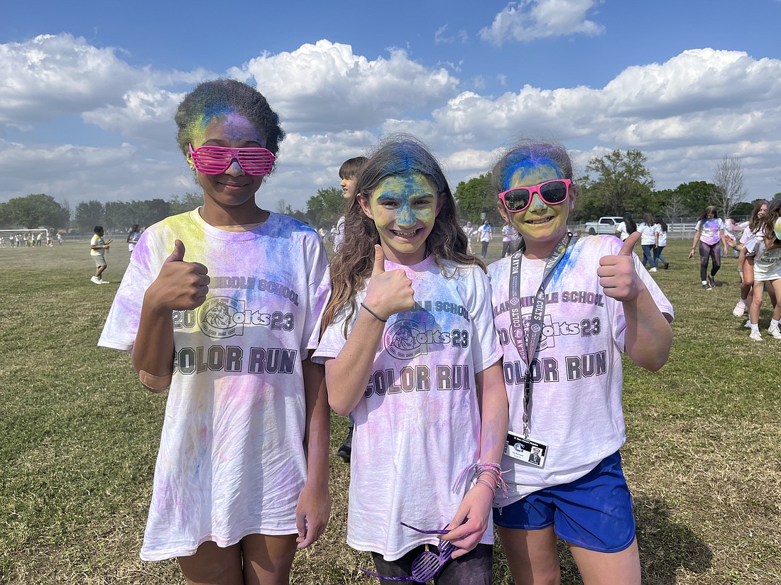 Sixth graders Jaliyh Tartt, Sara Downs and Lily Bertrand love getting colors all over them.
