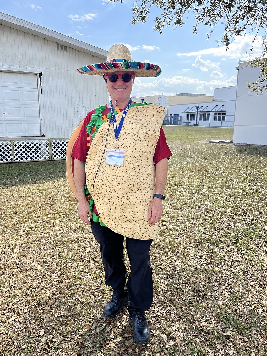 Scott Jeffers, a student support specialist, dresses as a taco after promising students he'd dress in a funny suit if they raised $10,000 through the Color Run.
