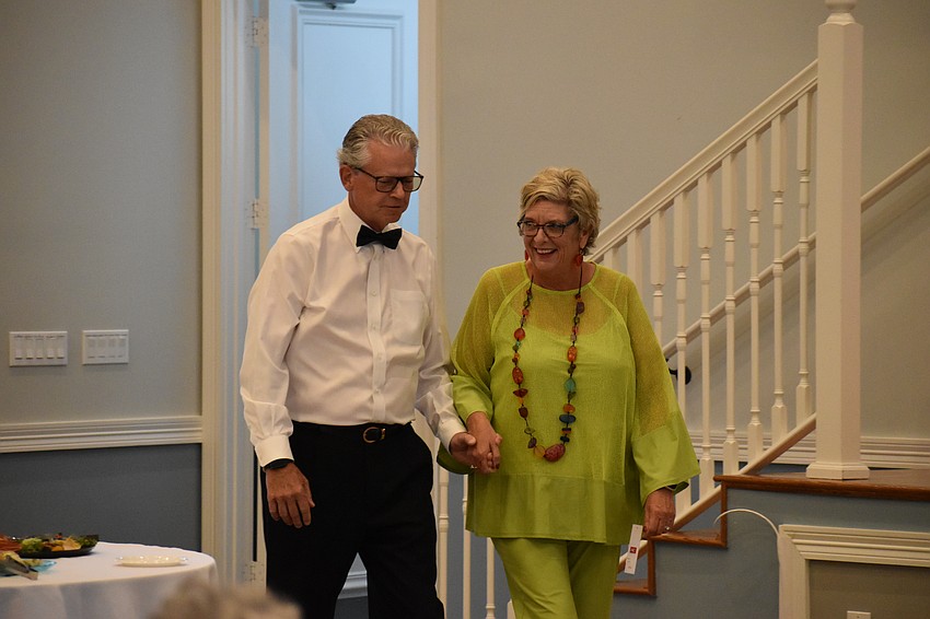 Charles King guides Terrie Thorstad towards the aisle.