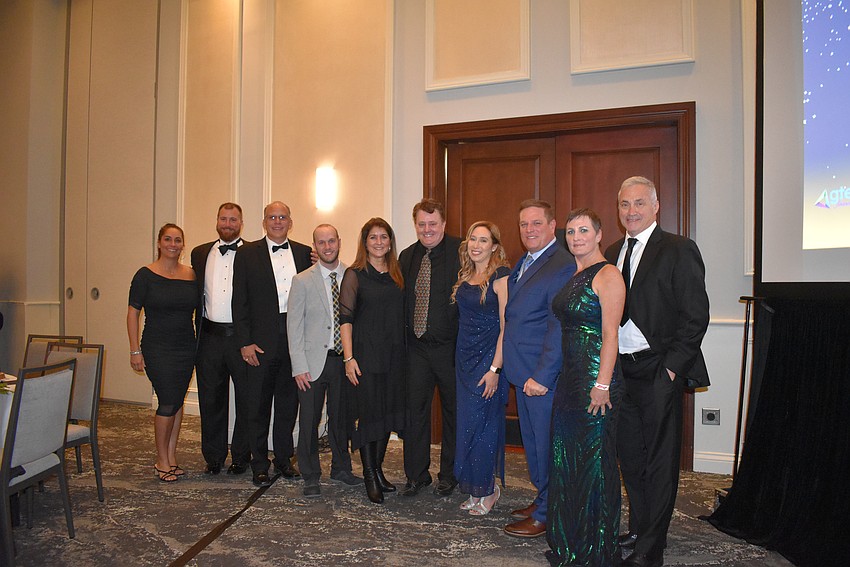 Dreamers Academy members join their construction team for a picture.