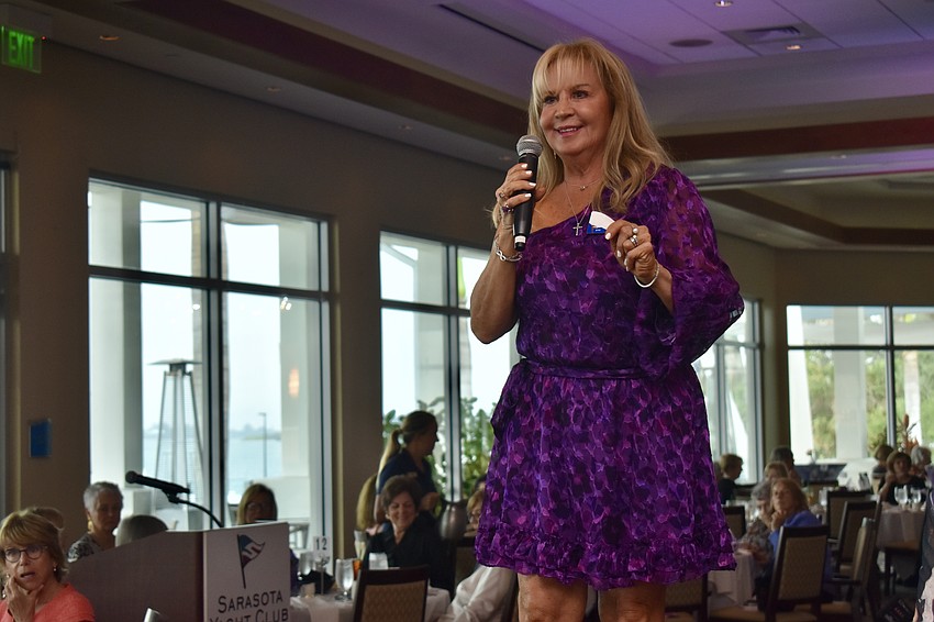 Chair Kathy Callahan calls out the winning raffle tickets.