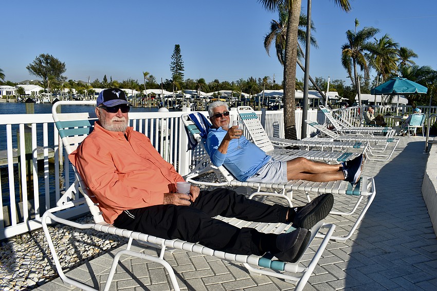 Walter and Karl Hasenfus lounge by the pool.