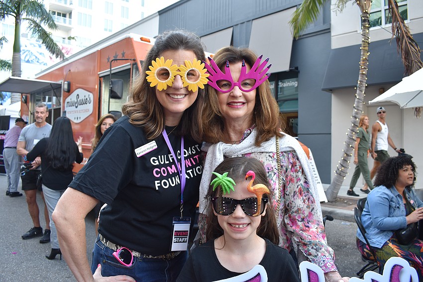Gulf Coast Community Foundation staff member Kameron Hodgens, Debbie Partridge, and 7-year-old Evelyn Hodgens