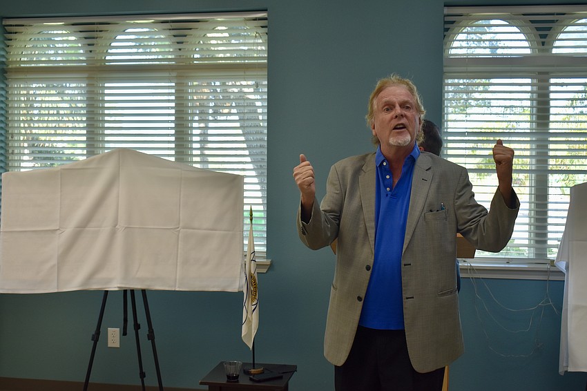 Jim Whitman leads the club in singing the national anthem.