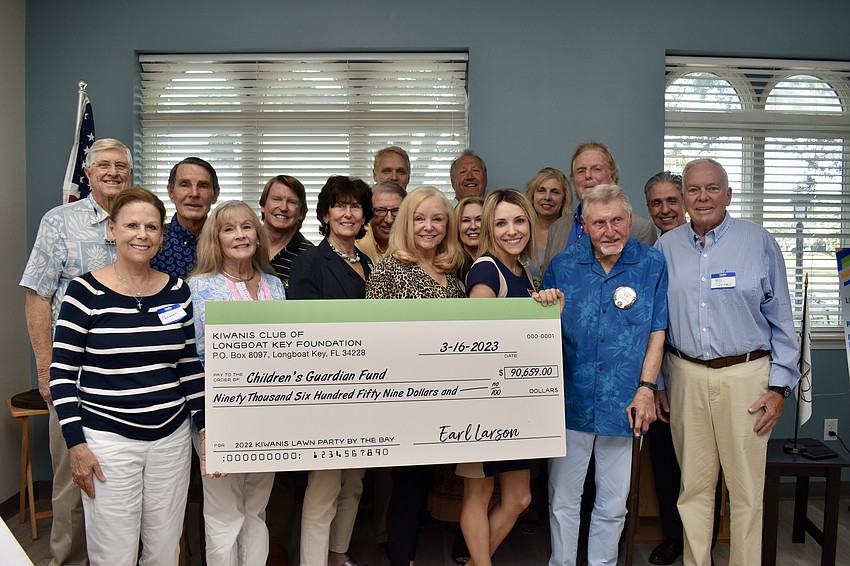 Kiwanis members gather to present the proceeds of the Lawn Party held on Dec. 5, 2022 to the Children's Guardian Fund.
