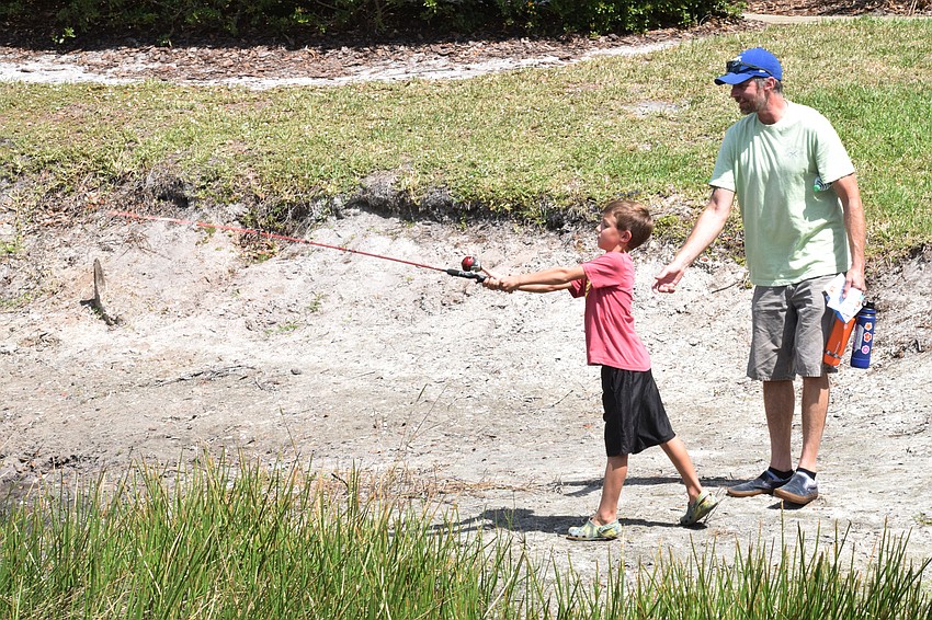 Lucas Meleshenko, who is 7, gets advice on casting from his father, Josh Meleshenko.