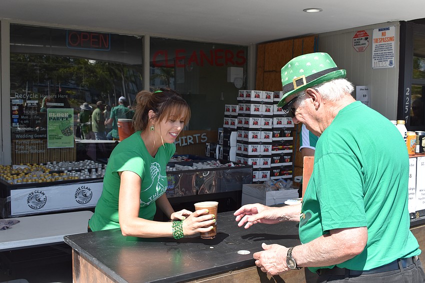 Lori Anderson brings a beer for Ron Longhurst.