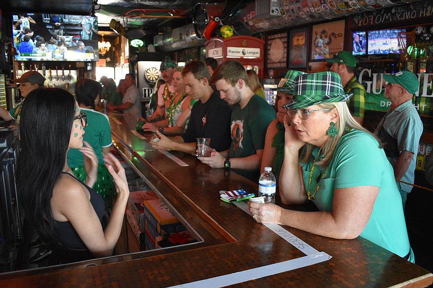Karen Marquez serves Kathryn Sperber inside the pub.