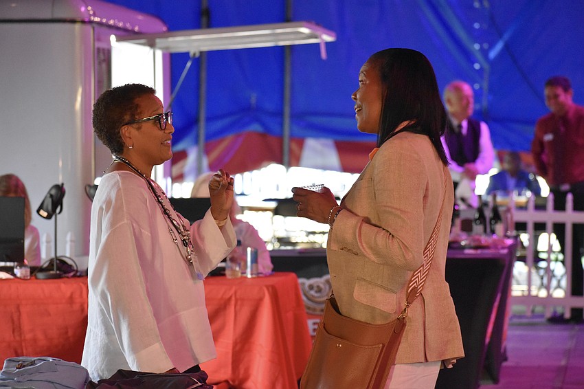Jazz Club volunteer Sherelle Matthews and Ingrid Summers catch up with one another.