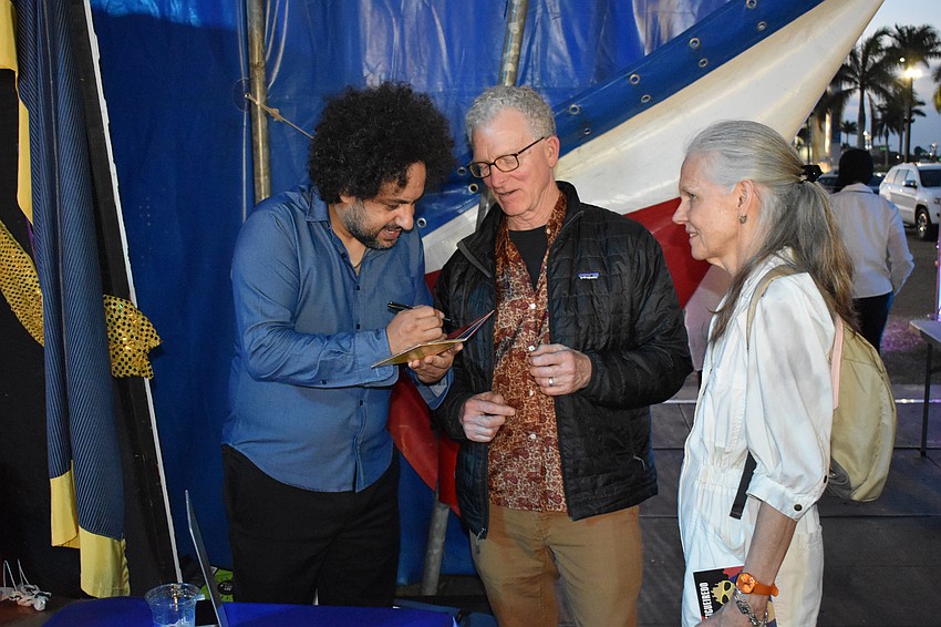 Diego Figueiredo signs an album for Stuart and Tracey Kirchner.