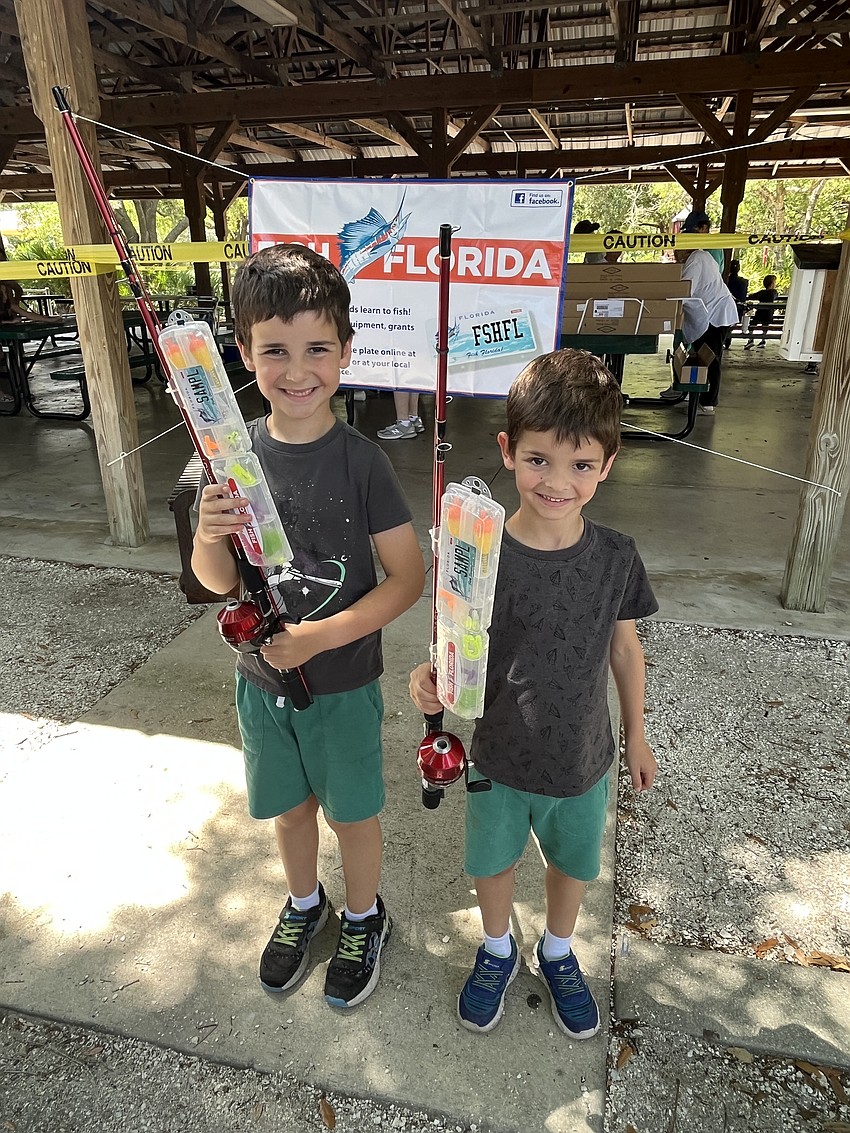Lakewood Ranch's 7-year-old Levi Schwartz and 5-year-old Jacob Schwartz are thrilled to have new fishing rods.