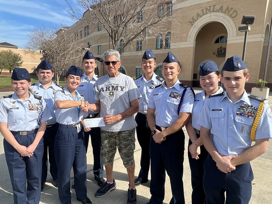 The Mainland High School ROTC presents the check to Jewish Federation President Marvin Miller. Courtesy photo