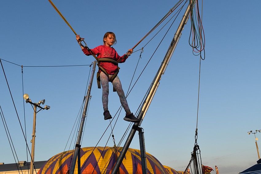 9-year-old Zoe Johnston does the bungee jump.