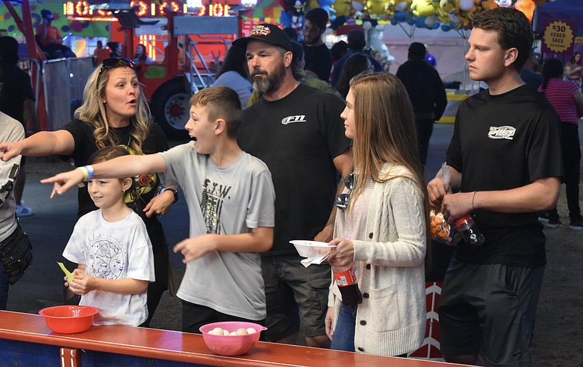 Danielle Mocny, 8-year-old Kylie Mocny, and 11-year-old Tanner Mocny play ball toss as Mike Mocny, Nichole Medeisis, and Gage Burch look on.