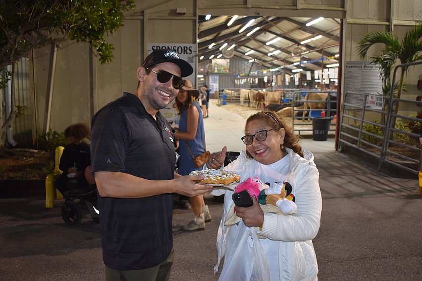 Ricky Rowles and his mother Jennifer Ashton split a funnel cake.