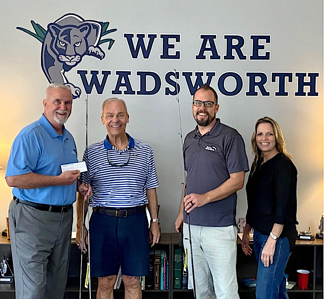 Wadsworth Elementary School Principal Paul Peacock, left, accepts a check from the Flagler Sportfishing Club with FSC member Jeff Murphy, WES dean Cody Anderson and FSC member Deb Thomas.