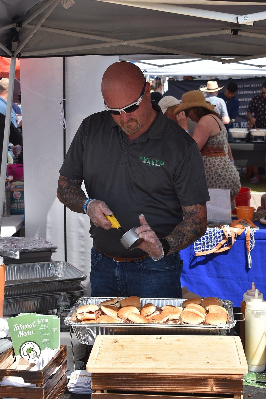 Kelly's Roast Beef franchise owner for UTC, Jeff Doward, prepares sample sandwiches.
