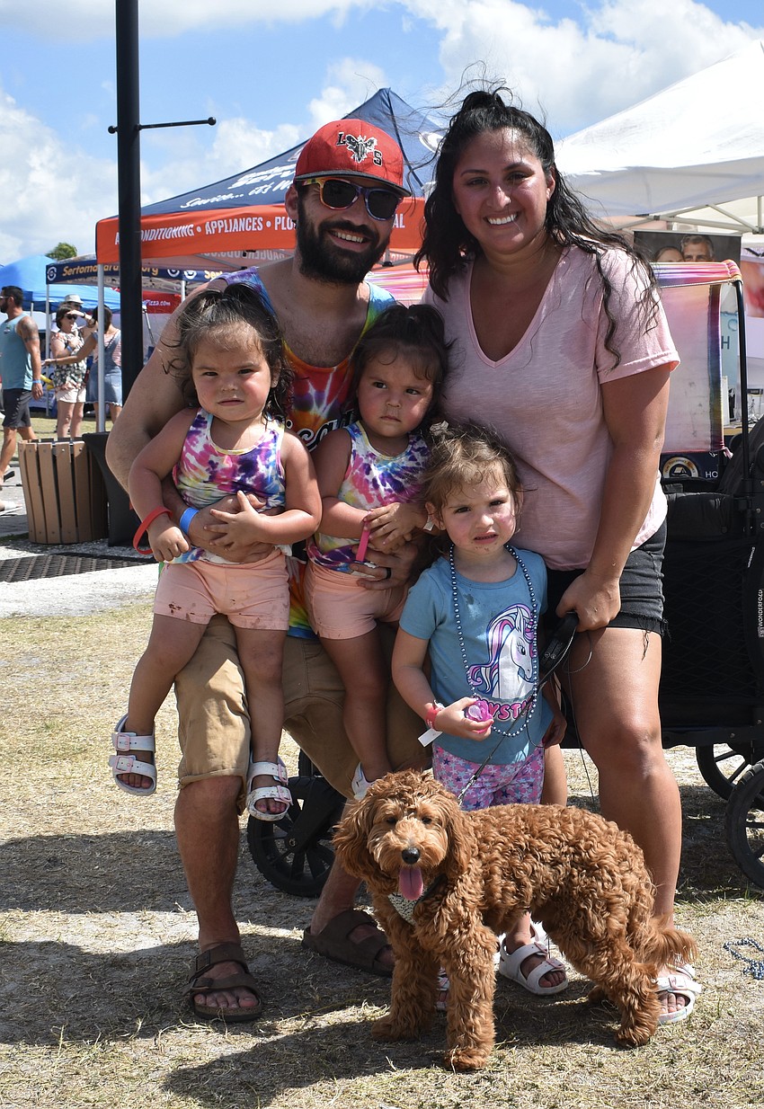 Venice's Veronica and Neil Anderson, their children, 2-year-old Michaela Anderson, 2-year-old Makenna Anderson, and 3-year-old Helena Anderson, and their Goldendoodle Noodles