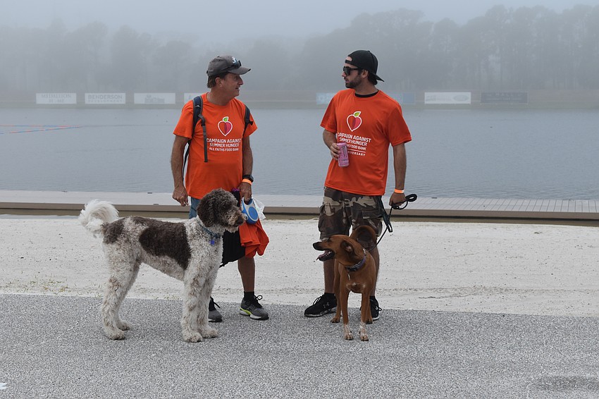 Charles Sweigard walked with Beau, a Labradoodle, while David Sweigard walked with Tula, a hound mix.