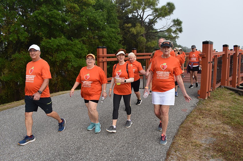 Todd Griffie, Melanie Jendreski, Michele Heaven, and Peggy Cox cross the bridge during the walk.