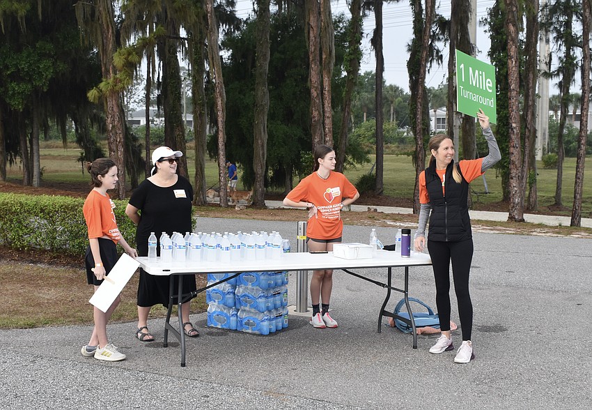 The 1-mile turnaround point was staffed by 12-year-old Emory Frandsen, Kim Allen, 16-year-old Reese Allen, and Kelly Fitzgerald of National Charity League.