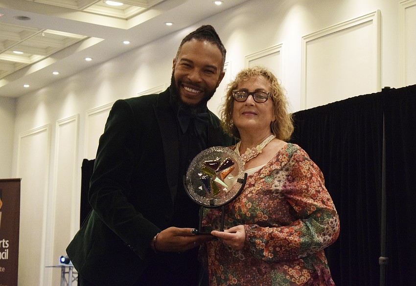 Ricardo Robinson-Shinall, the theater director at Braden River High School, presents Roxane Caravan, the theater director at Lakewood Ranch High School, with the Dr. Sherry Lawrence Theatre Education Award.