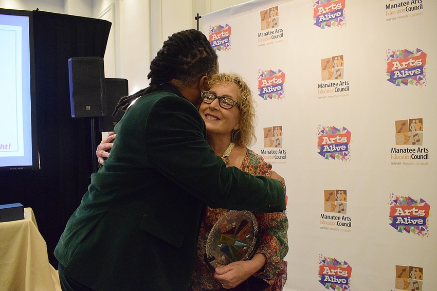 Ricardo Robinson-Shinall, the theater director at Braden River High School, congratulates Roxane Caravan, the theater director at Lakewood Ranch High School, on receiving the Dr. Sherry Lawrence Theatre Education Award.