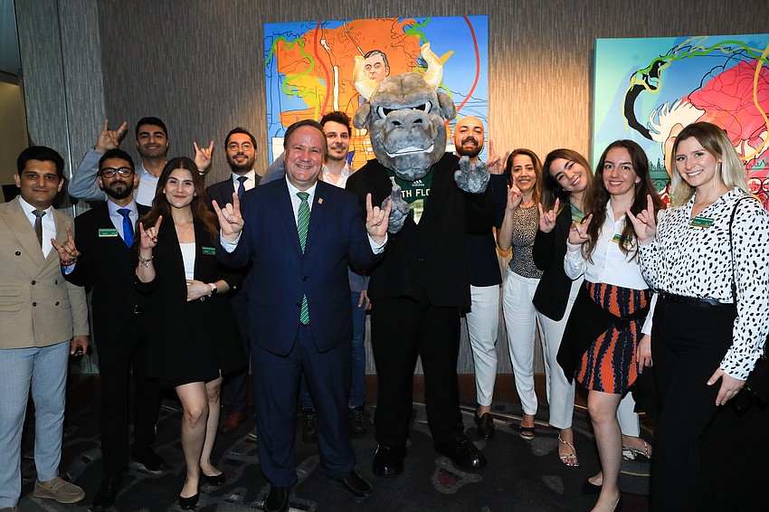 USF School of Hospitality and Tourism Management Dean Cihan Cobanogalu with USF students
