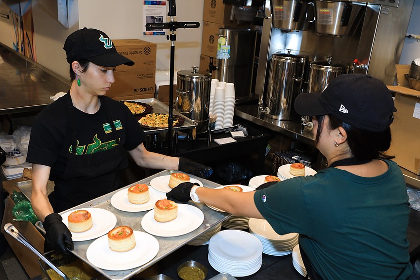 Lisa Rosario receives a tray of smoked salmon Vol-au-vent.