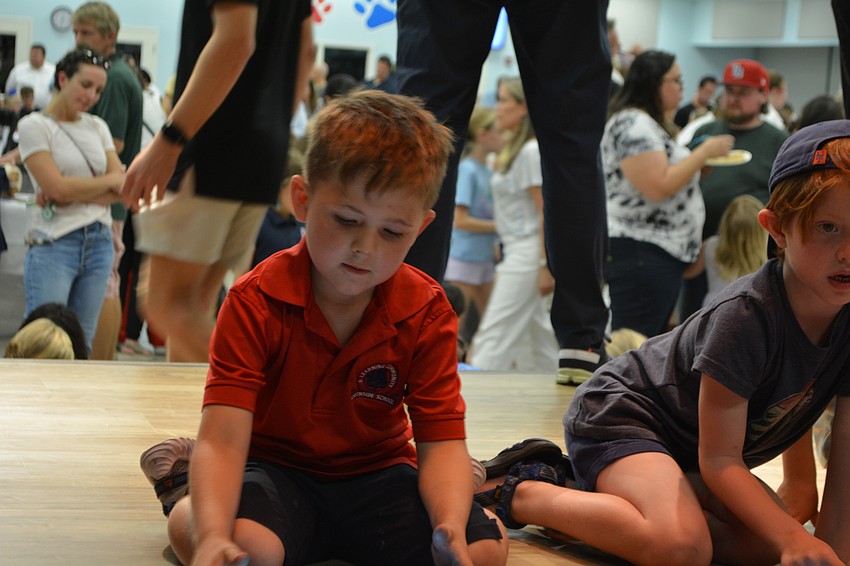 Lucas Gutherz, a kindergartner at Southside Elementary, experiments with using an iPad as a remote control for wirelessly connected spheres at the school's STEAM Night on Thursday.