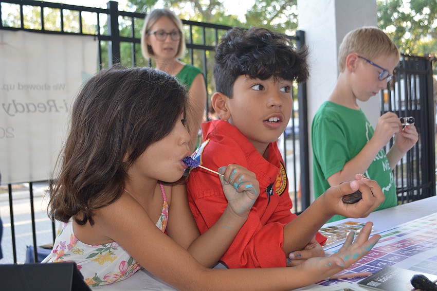 Oliver S., a second grader, and Arianna S., a kindergartner, learn about meteorites.