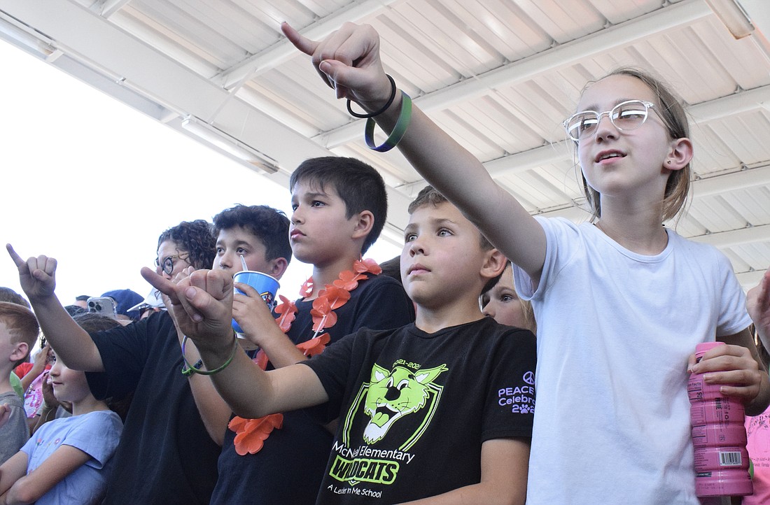Gilbert W. McNeal Elementary School's Noble Pinto, Julian LaBranche, Jaxon Grew and Chloe Kenya pinky promise to go out and play in honor of Justin Darr, who was a physical education teacher.