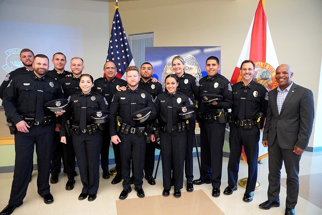 Sarasota Police Chief Rex Troche, Deputy Chief Scott Mayforth and City Manager Marlon Brown with 10 new patrol officers who were sworn in on Thursday.