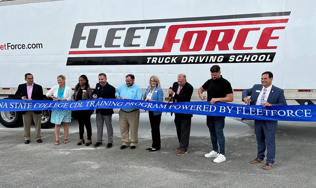 Representatives from Daytona State College and FleetForce cut the ribbon, signaling the launch of the new commercial driver's license training program. Courtesy photo
