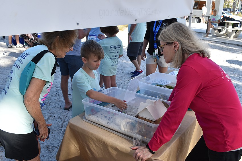 Sara Myers and AJ Frye learn about keeping beaches safe for turtles from Connie Schindewolf of Longboat Key Turtle Watch.