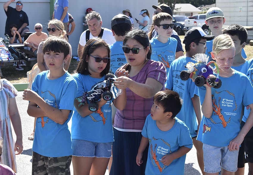 11-year-old Charlotte Huynh of team Mako prepares for the race with her mother Harper Huynh and her 6-year-old brother Charlie Huynh.